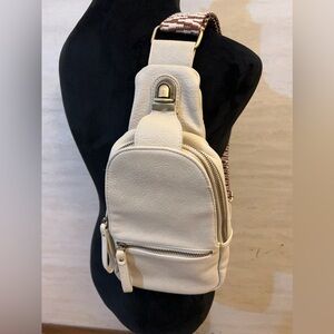 Urban Expressions Liberty leather sling bag with a chevron pattern strap.